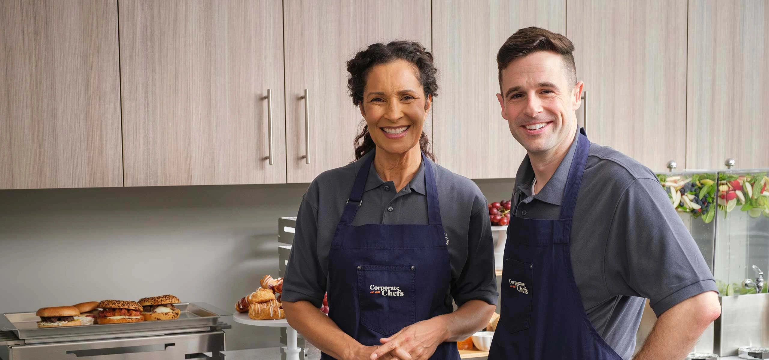 Two employees happily smiling at camera